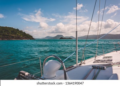 Sailboat sailing on a warm beautiful day in the Whitsunday Islands on the Great Barrier Reef in Australia.