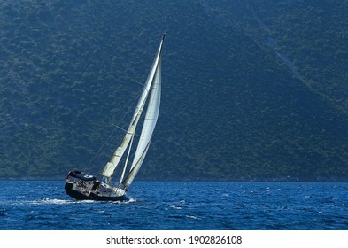 Sailboat sailing upwind at the coast of the Greek island of Ithaca in the Ionian Sea