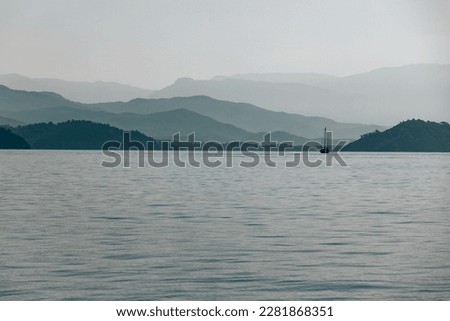 Sailboat in the sea with moutains landscape