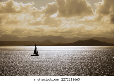 Sailboat silhouette in warm sunlight 