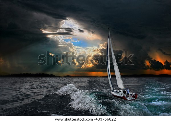 Sailboat in the storm\
sea.Yacht and beautiful seascape.Travel on a sailing boat.A\
hurricane in a stormy\
sea.