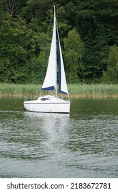 Sailboat Swimming On A Lake - Side View