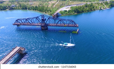 SAILBOAT AND SWING BRIDGE. JULY 2, 2018. LITTLE CURRENT, ONTARIO CANADA