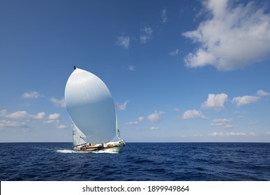 Sailboat With White Spinnaker Sailing Downwind