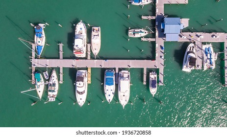 Sailboat, Yacht, Boat Dock. Aerial View Of Dock. Boats Moored By The Pier. Ocean Blue-green Saltwater. Spring Break Or Summer Vacations In Florida. Boat Fishing Tour. Top View. 