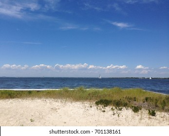 Sailboats on Great South Bay viewed from the shore of Fire Island, Saltaire, NY.