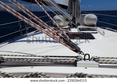 Sailing in Adriatic, Croatia. Yacht equipment: colorful rope on the mainsheet traveler car.