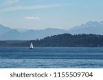 Sailing in the blue water of the puget sound with the olympic mountains in the background