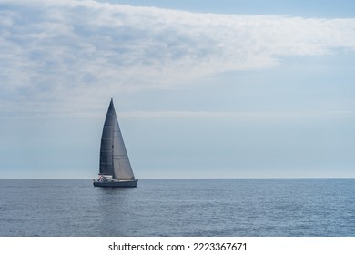 Sailing Boat On Blue Open Sea. Concept Of Uncertain Future, Suspense And Peradventure