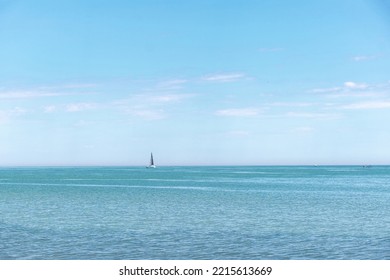 Sailing Boat In Open Water Seeing From A Distance On A Sunny Day