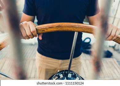 Sailing Boat Pilot Following The Compass