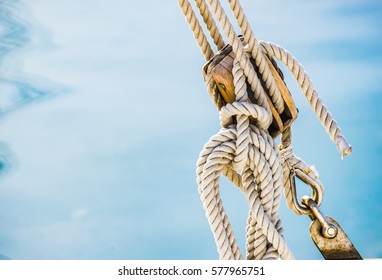Sailing boat pulley, block and tackle with moored nautical rope.