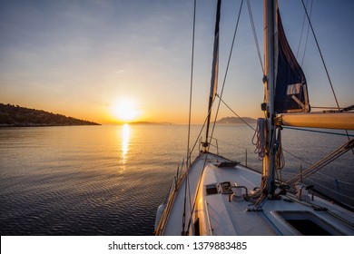 Sailing boat in the sea during awesome sunset. Luxury yacht and cruise holiday.