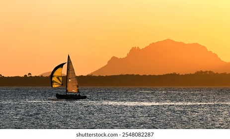 Sailing boat at sunset with scenic view of the Esterel massif and Saint Marguerite island from Cap d'Antibes on French riviera in widescreen format - Powered by Shutterstock