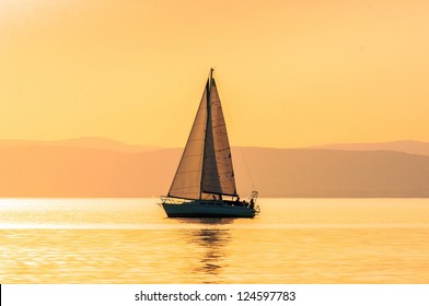 Sailing boats with a beautiful sunset at the sea - Powered by Shutterstock