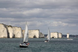 Sailing Boats In Front Of Old Harry's Rock On The Jurassic Coast Near Poole