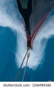Sailing Bow breaks a wave