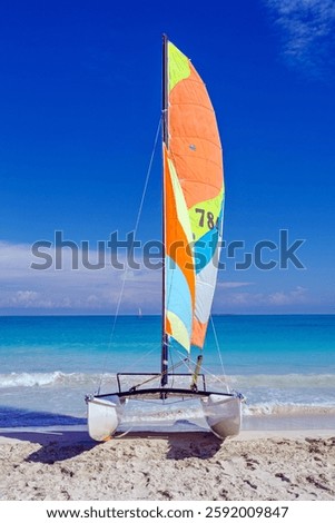 Sailing catamaran on the Atlantic Ocean coast. Active recreation, sports, water entertainment concept. Vertical photo. Caribbean, Latin America. Varadero, Matanzas Province, Cuba.