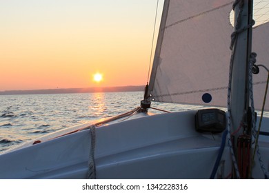 Sailing dinghy on the way to the sunset