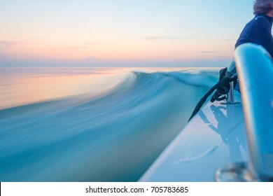 Sailing Fast In Smooth Water Of A Lake At Sunset 