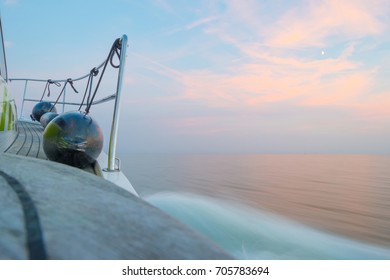 Sailing Fast In Smooth Water Of A Lake At Sunset 