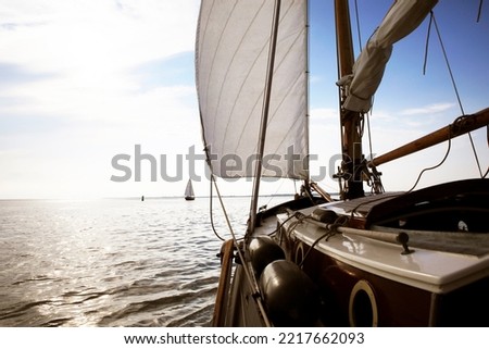 Sailing a flat bottom yacht at the Wadden Sea, The Netherlands
