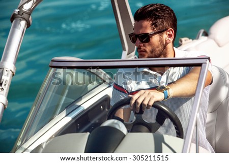 Sailing man on yacht in ocean