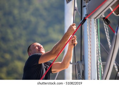 Sailing, Man Pulling Ropes. Luxery Yacht Boat.