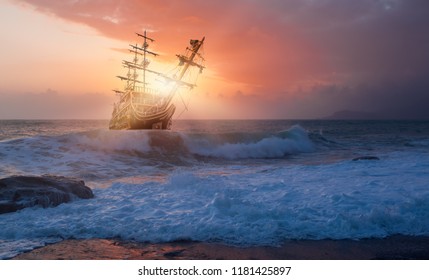 Sailing Old Ship In Storm Sea Against Dramatic Sunset