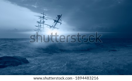 Sailing old ship in a storm sea in the background stormy clouds