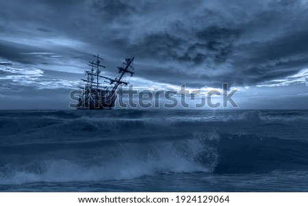 Sailing old ship in a storm sea in the background stormy clouds