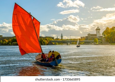 Sailing on boat with red sail