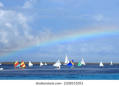 Sailing regatta competition sunfish boats sport colorful rainbow sky Caribbean coast