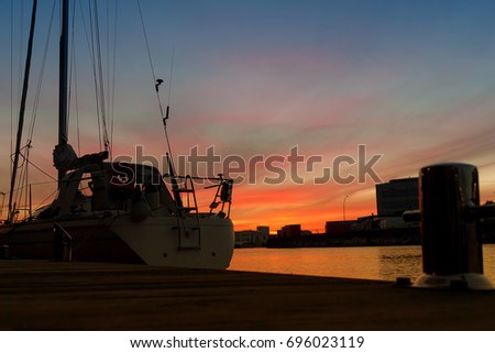 Sailing ship at boat dock in sunset