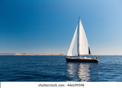 Sailing ship luxury yacht with white sails in the Sea. 