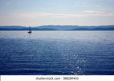 sailing ship on a mountain lake in good weather on a background of blue sky. nature background. yachting - Powered by Shutterstock