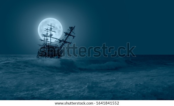 Sailing ship in storm sea against\
full moon \