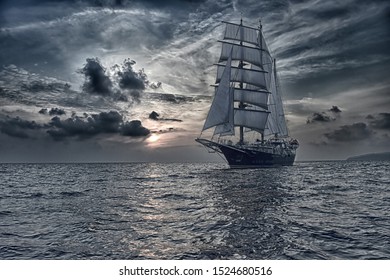 Sailing Ship Under White Sails And Stormy Sunset Sky. Yachting. Travel