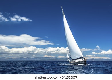 Sailing. Ship yachts with white sails in the open Sea. Luxury boats.