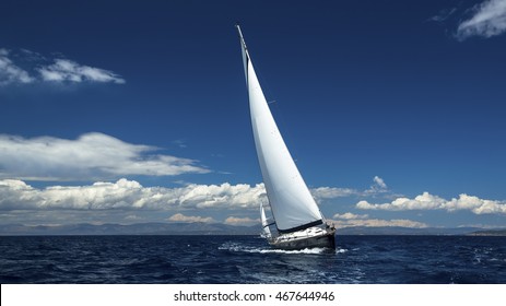 Sailing ships yachts with white sails in the open sea.  - Powered by Shutterstock