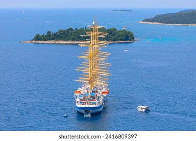 Sailing tall ship cruise . Ship with large masts near island in Adriatic Sea in Croatia 