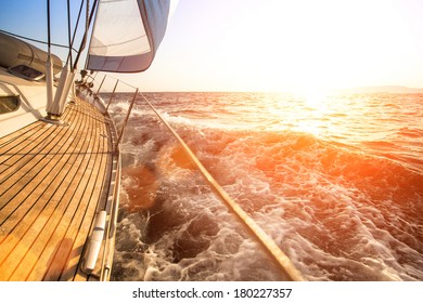 Sailing yacht against sunset. Luxury yachts.