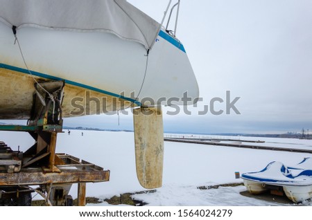 Sailing yacht on a cart in winter.Yacht on the pier in winter.