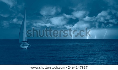 Sailing yacht in a stormy weather with thunder and lightning