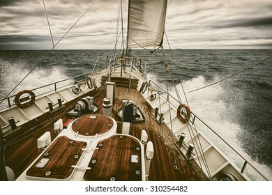 Sailing yacht at sunset during a storm. Toned image and blur. Retro style postcard. Sailing. Yachting. Travel