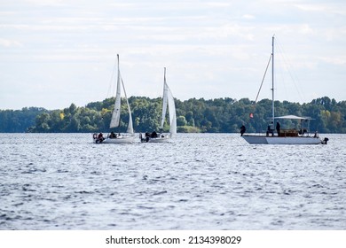 Sailing Yachts At The Finish Line And Trimaran