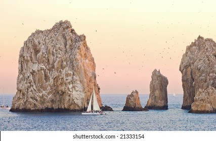 Sailing In A Yellow And Orange Sunset Around Los Arcos In Cabo San Lucas, Mexico