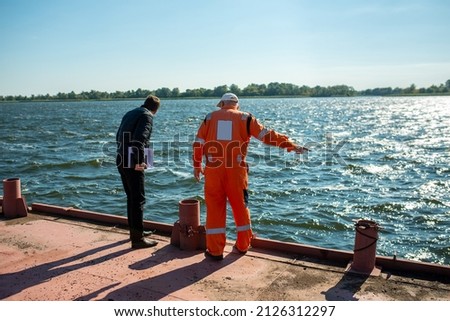 sailor communicates with the superintendent on the deck in the port