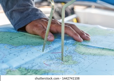 Sailor With Divider In Front Of Navigation Chart Of Coastal Area. Captain Navigating Sail Boat Ship