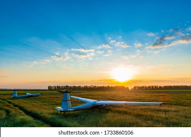 Sailplanes on the grassy field are ready for adventure. Beautiful surise at the airfield. 